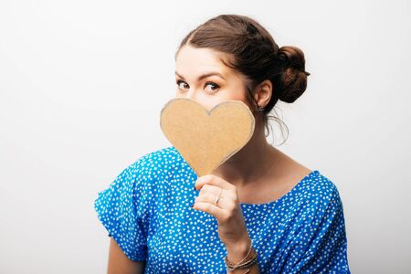 girl holding a paper heartの写真素材
