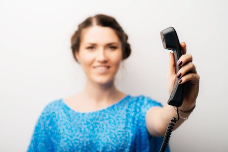 girl holds up the phoneの写真素材
