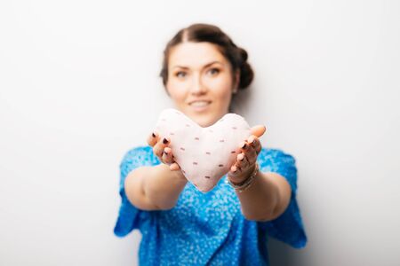 girl holding a toy a little heartの写真素材