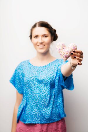 girl holding a toy a little heartの写真素材