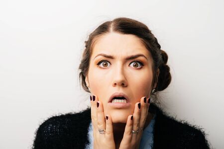 Woman thinks dissatisfied, angry, resentful. Isolated on a white backgroundの写真素材