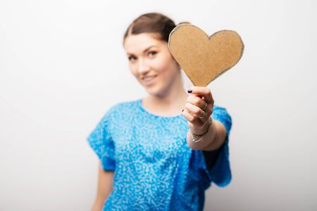 girl holding a paper heartの写真素材