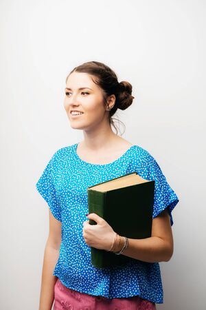 girl holding a bookの写真素材