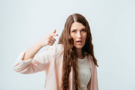 on a gray background young girl shows on youの写真素材