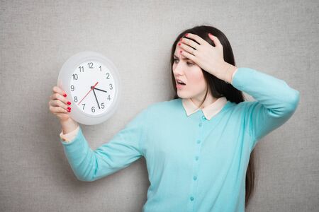 girl holding a clock