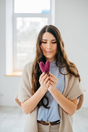 girl hold handmade knitted heartの写真素材