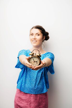 beautiful girl with an alarm clock in handsの写真素材