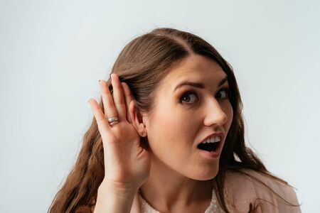 on a gray background young girl overhears