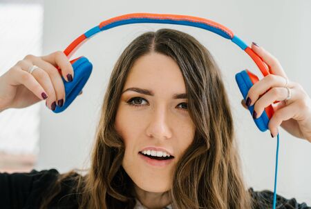 brunette woman listening to the music wearing headphones