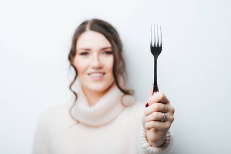 Girl and fork on gray backgroundの写真素材