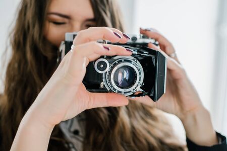 long-haired brunette girl photographed on an old cameraの写真素材