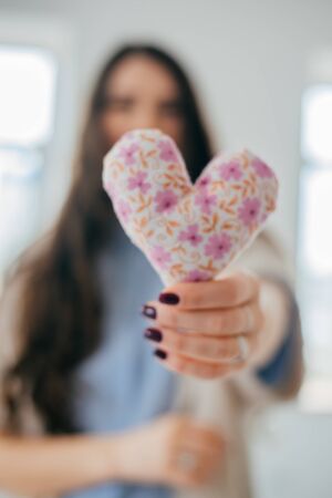 hands holding a soft heart shapeの写真素材