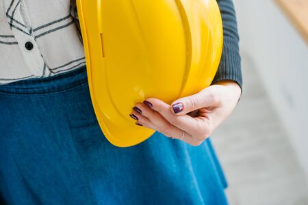 young girl holding a construction helmetの写真素材