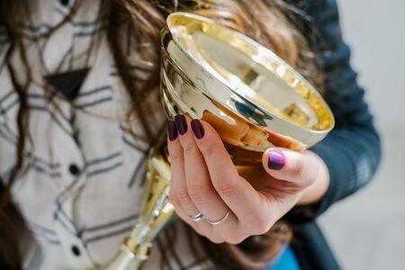 young girl holding a prize cupの写真素材