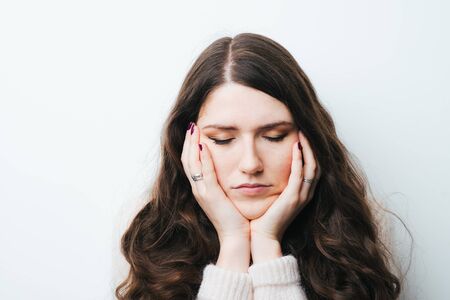 brunette girl tired on a white background