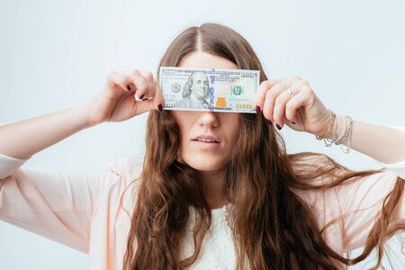 on a gray background young girl with dollarsの写真素材