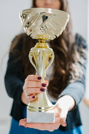 young girl holding a prize cupの写真素材