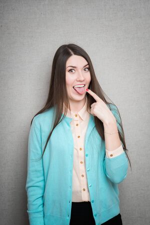 Girl sticking her tongue out, isolated