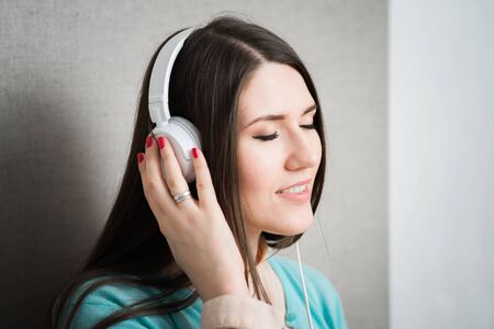 girl listening to music on the white headphones