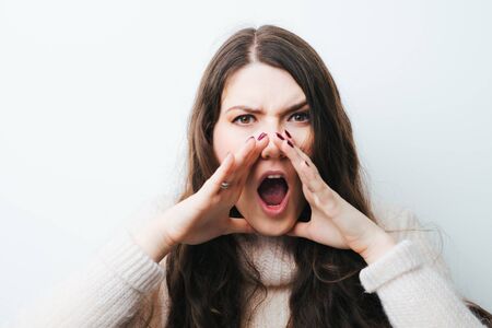 brunette girl calling someone on a white background
