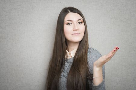 young casual woman with a smile on her face and her arms wide openの写真素材