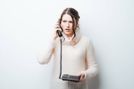 on a white background girl talking on the phone workingの写真素材