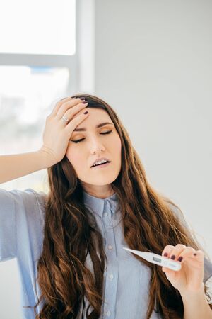 Young woman checking temperature close up shoot