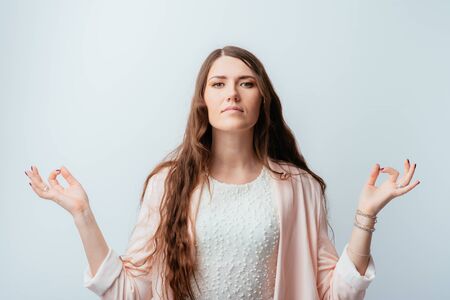 on a gray background young girl meditatesの写真素材