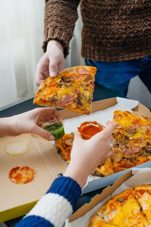 boy and girl share a pizzaの写真素材