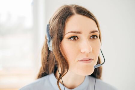 Close-up portrait of a customer service agent near the windowの写真素材