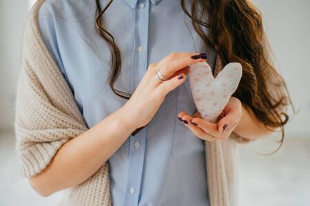 hands holding a soft heart shape