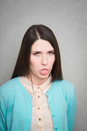 Girl sticking her tongue out, isolatedの写真素材