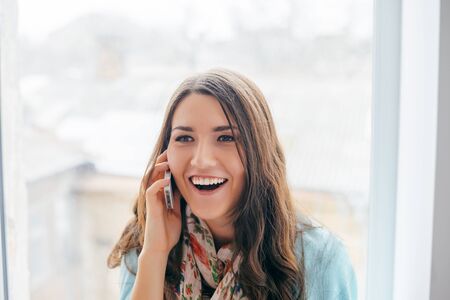 pretty young girl speaking by mobile phoneの写真素材