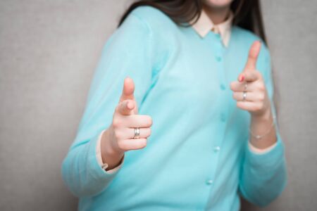 Young woman  points her fingersの写真素材