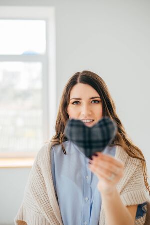girl holding handmade knitted heartの写真素材