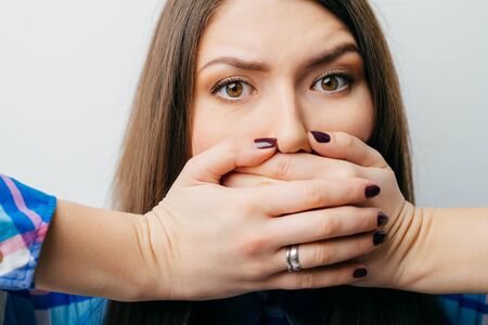woman with hands over her mouth