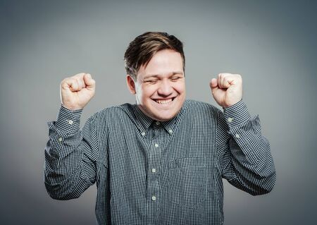 Portrait of surprised victory young manの写真素材