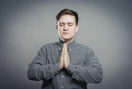 Man Praying With Hands Closedの写真素材