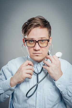 The doctor in a white lab coat holding a stethoscopeの写真素材
