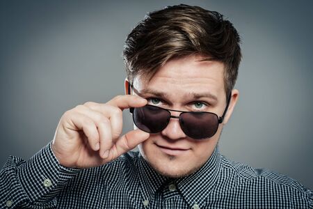 Studio photo of young attractive man in glassesの写真素材