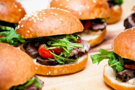A platter full of hamburgers ready for consumptionの写真素材