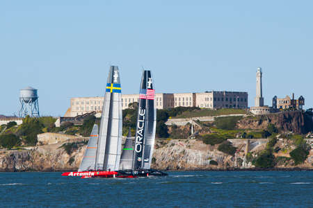 Yachts competing in the America's Cup in 2013 practice in front of Alcatraz, San Francisco, USA