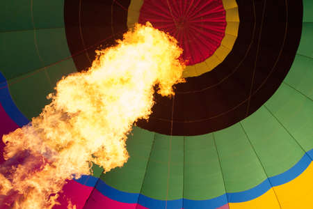 A blast of gas ignites filling the balloon with hot air on a cold winter's morning in Yarra Valley, Victoria, Australiaの写真素材