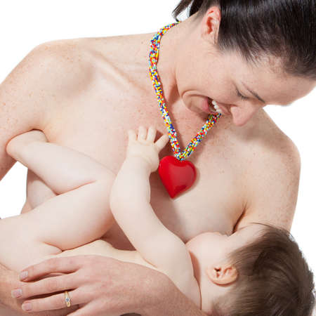 A young mother holds her breast feeding babyの写真素材
