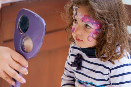 A girl has her face painted in California, USAの写真素材