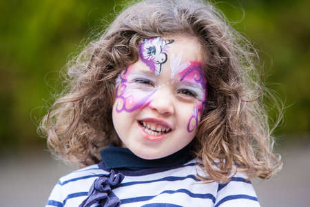 A girl has her face painted in California, USA
