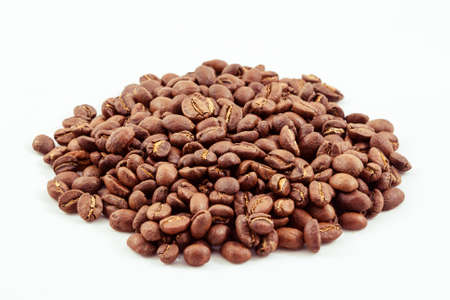 An isolated pile of coffee beans before grindingの写真素材