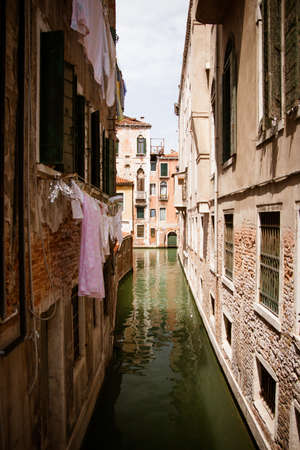 Canals in between houses in Venice, Italyの写真素材