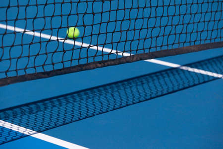 Tennis court with a ball and net closeup in Melbourne, Australiaの写真素材