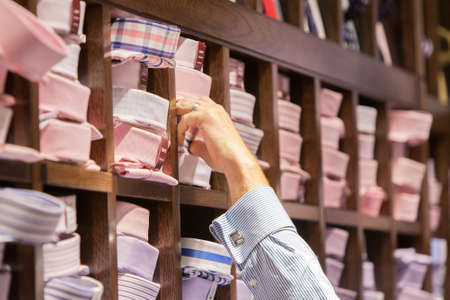 A man chooses a shirt in a boutique store in Melbourne, Australiaの写真素材